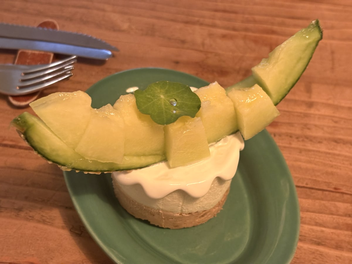 A melon-topped cream cake on a green plate at a Yeonnam-dong cafe in Seoul.