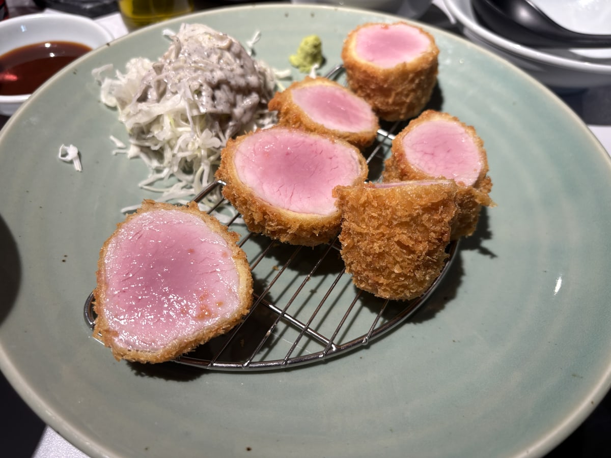 A close-up of thick tenderloin-style pork katsu pieces on a rack at Heki Mangwon